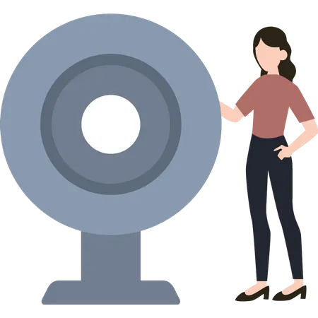 A girl is standing next to a webcam  Illustration