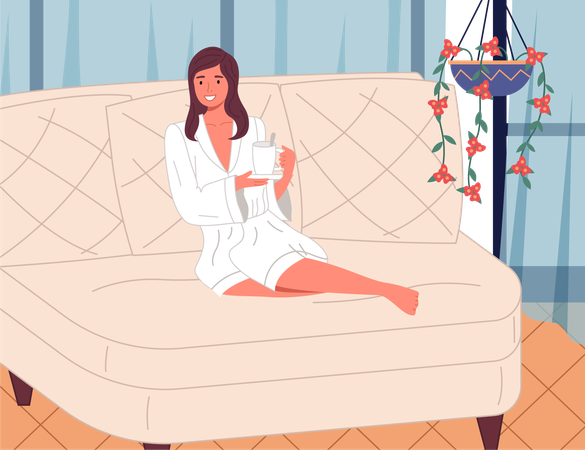 Beautiful young girl in terry white bathrobe on the couch with cup of drink  Illustration