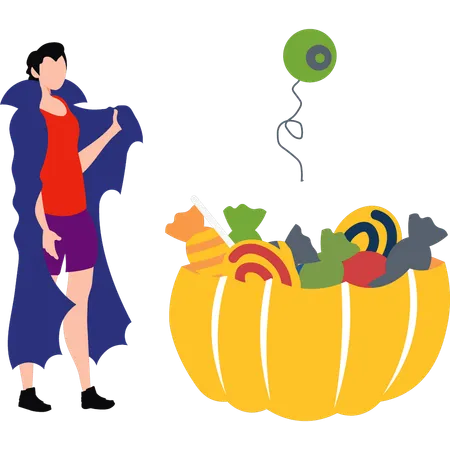 Boy standing with a basket of Halloween candy  イラスト