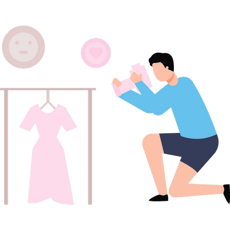 El chico está haciendo una sesión fotográfica de vestidos.  Ilustración