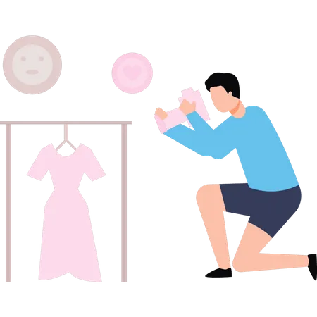 El chico está haciendo una sesión fotográfica de vestidos.  Ilustración