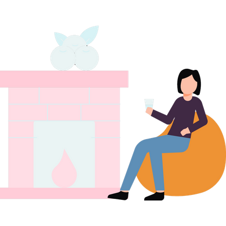 Femme assise devant la cheminée  Illustration