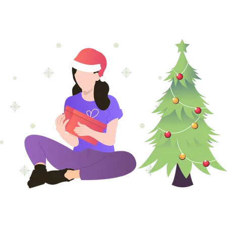 Fille assise près du sapin de Noël et tenant une boîte-cadeau  Illustration