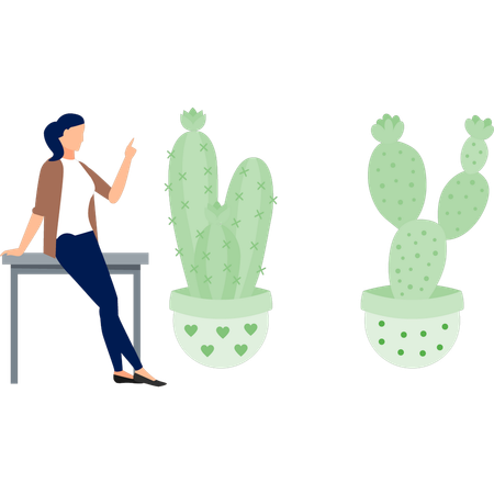 Fille assise sur une table pointant une plante verte  Illustration