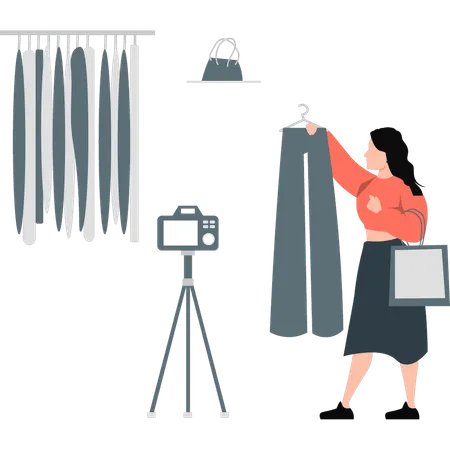 Fille réalisant des vidéos promotionnelles pour des vêtements  Illustration