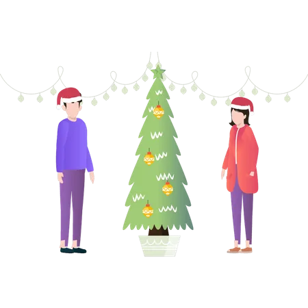 Garçon et fille debout près de l'arbre de Noël  Illustration