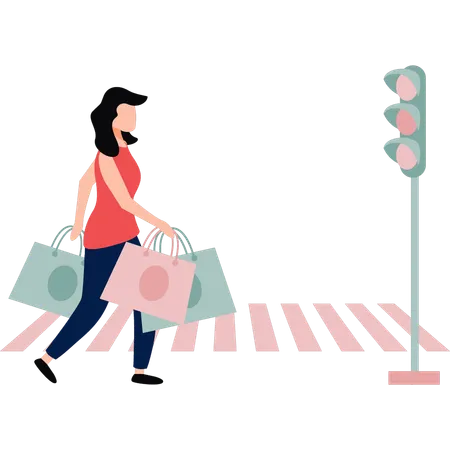 Garota está atravessando a rua com sacolas de compras na mão  Ilustração