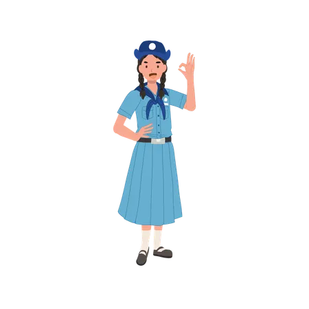 Giovane ragazza scout tailandese positiva e sicura in uniforme allegra che fa gesto giusto della mano  Illustration