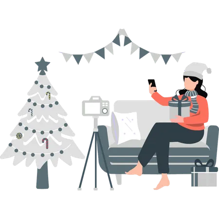 Girl making video with Christmas presents  Illustration