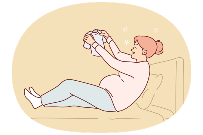 Happy pregnant woman sits on bed holding small t-shirt for baby in Hand  Illustration