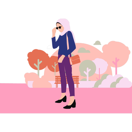 Hijabi girl is standing in the park  イラスト