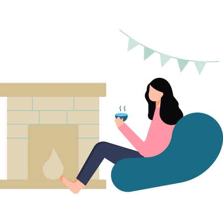 La niña está bebiendo té junto a la chimenea.  Ilustración