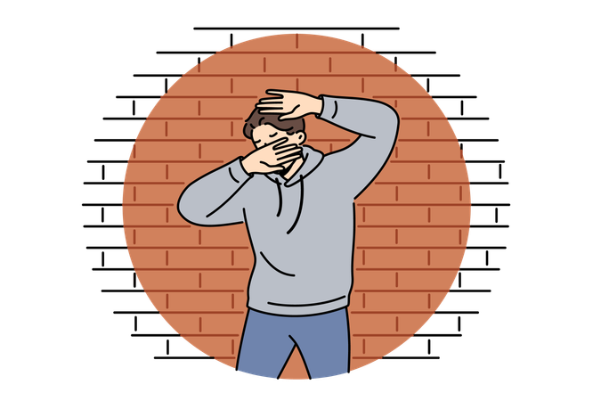 Man criminal in light of police lantern stands near brick wall and covers face with hands  Illustration