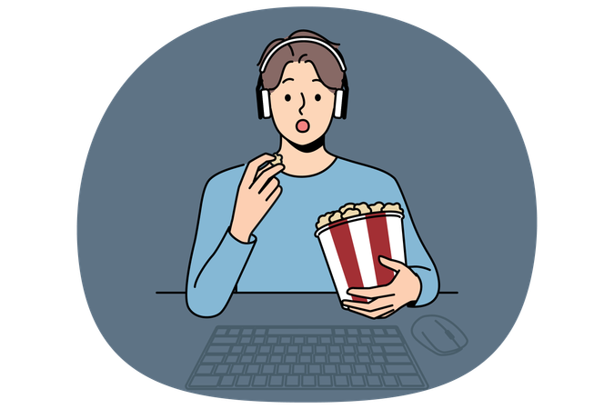 Man with popcorn watches movie sitting at table with computer and looks at screen intrigued  Illustration