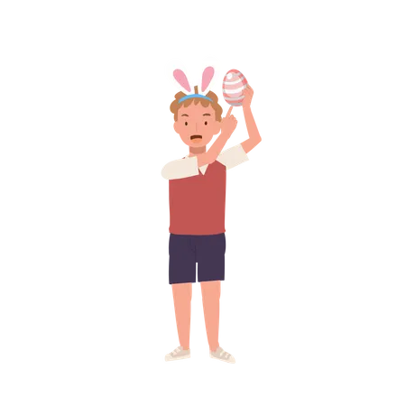 Niño feliz con orejas de conejo sosteniendo un huevo de Pascua mientras lo señala con el dedo índice para mostrarlo  Ilustración