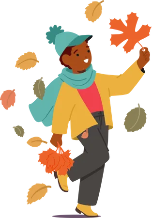 Personnage de petit garçon se promenant avec une poignée de feuilles d'automne vibrantes dans ses mains  Illustration