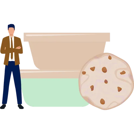 The man is standing next to the biscuits of the bakery  Illustration