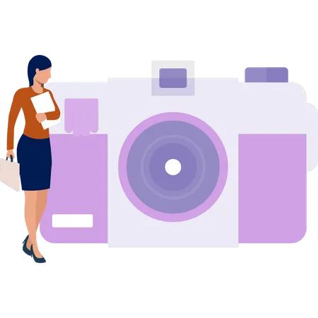 Woman standing next to  camera  Illustration